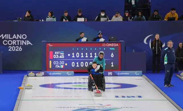 Katlin Riidebach, of Estonia, competes in a wheelchair curling mixed doubles round robin session against Italy at the 2026 Winter Paralympics, in Cortina d'Ampezzo, Italy, Thursday, March 5, 2026. (AP Photo/Evgeniy Maloletka)