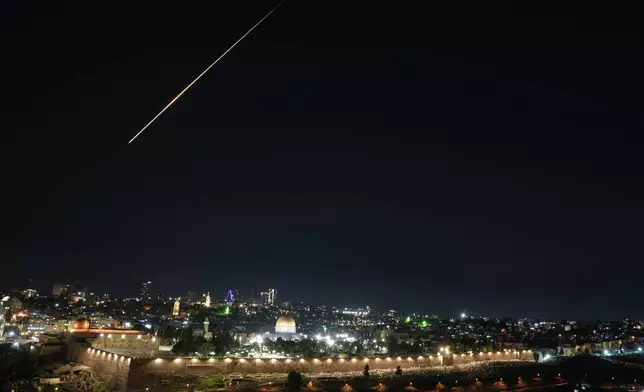 Trace of an air defense missile interception during an Iranian attack is seen over Jerusalem's Old City, Sunday, March 1, 2026. (AP Photo/Mahmoud Illean)