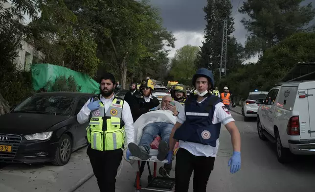 Paramedics evacuate wounded people from the site of a deadly Iranian missile strike in Beit Shemesh, Israel Sunday, March 1, 2026. (AP Photo/Leo Correa)
