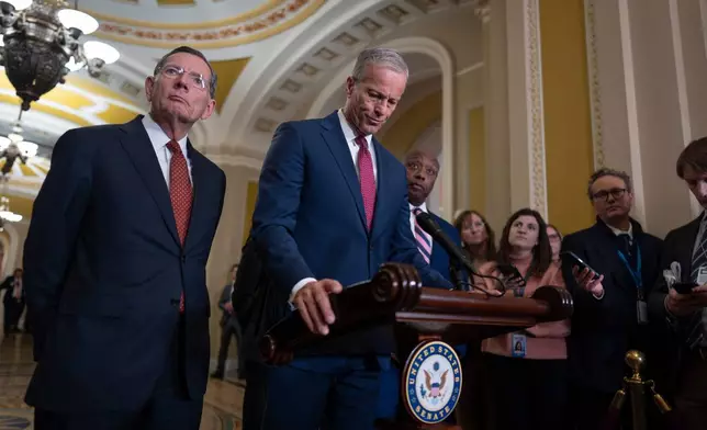 Senate Majority Leader John Thune, R-S.D., center, joined at left by Sen. John Barrasso, R-Wyo., the GOP whip, speaks to reporters at the Capitol in Washington, Tuesday, March 3, 2026. (AP Photo/J. Scott Applewhite)
