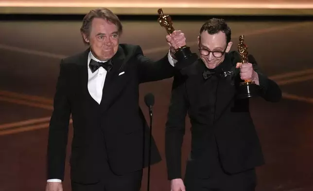 Maciek Szczerbowski, left, and Chris Lavis accept the award for animated short film for "The Girl Who Cried Pearls" during the Oscars on Sunday, March 15, 2026, at the Dolby Theatre in Los Angeles. (AP Photo/Chris Pizzello)