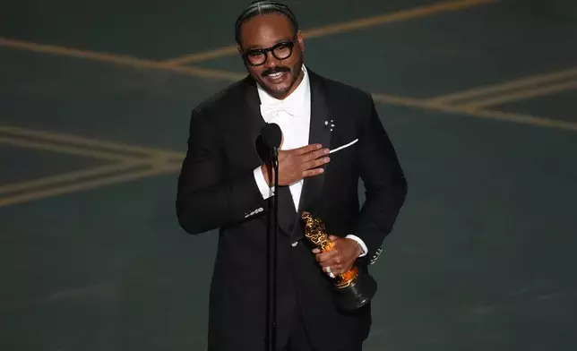 Ryan Coogler accepts the award for writing (original screenplay) for "Sinners" during the Oscars on Sunday, March 15, 2026, at the Dolby Theatre in Los Angeles. (AP Photo/Chris Pizzello)