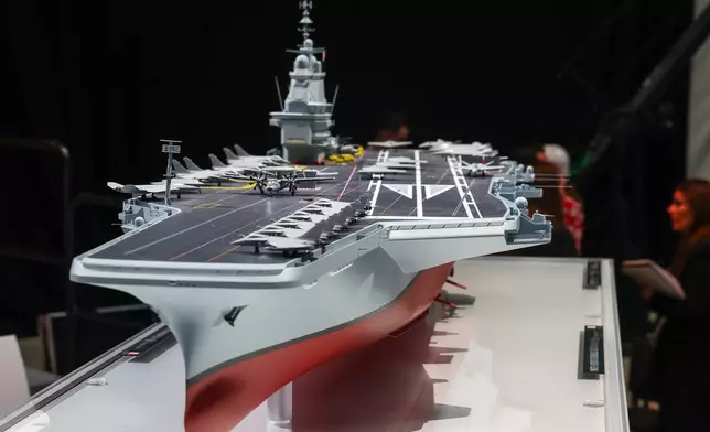 The model of the ship named "France Libre" is displayed, as French President Emmanuel Macron visits the construction site of Naval Group Nantes-Indret, where the next generation of French aircraft carrier is under construction, in Indret, France, Wednesday, March 18, 2026. (Gonzalo Fuentes/Pool Photo via AP)