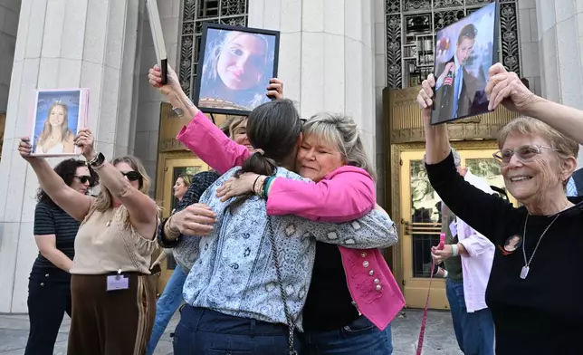 Lori Schott, center right, embraces Mary Rodee after the verdict in a landmark trial over whether social media platforms deliberately addict and harm children at Los Angeles Superior Court, Wednesday, March 25, 2026, in Los Angeles. (AP Photo/William Liang)
