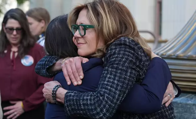 Laura Marquez-Garrett, attorney for SMVLC (Social Media Victims Law Center), embraces Julianna Arnold, right, parent, outside Los Angeles Superior Court on Thursday, March 12, 2026. (AP Photo/Damian Dovarganes)