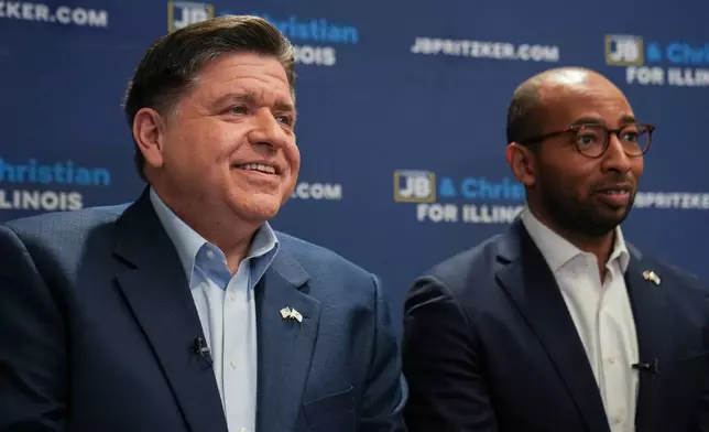 Illinois Gov. JB Pritzker, left, and running mate, candidate for lieutenant governor, speak during an interview, Wednesday, March 18, 2026, in Chicago. (AP Photo/Erin Hooley)