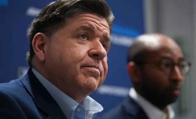 Illinois Gov. JB Pritzker, left, and running mate, candidate for lieutenant governor, Christian Mitchell speak during an interview, Wednesday, March 18, 2026, in Chicago. (AP Photo/Erin Hooley)