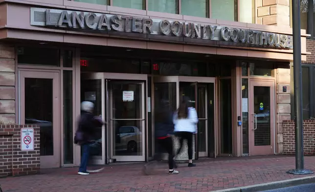 People enter the Lancaster County Courthouse in Lancaster, Pa., Wednesday, March 25, 2026. (AP Photo/Matt Rourke)