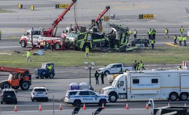 The wreckage of Port Authority fire truck is left on a tarmac after the wreckage of an Air Canada Express jet was moved from the runway, Wednesday, March 25, 2026, where they collided Sunday night at LaGuardia Airport, in New York. (AP Photo/Yuki Iwamura)