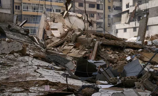 Debris litters a street from buildings damaged in an Israeli airstrike in Dahiyeh, Beirut's southern suburbs, Lebanon, Monday, March 16, 2026. (AP Photo/Bilal Hussein)