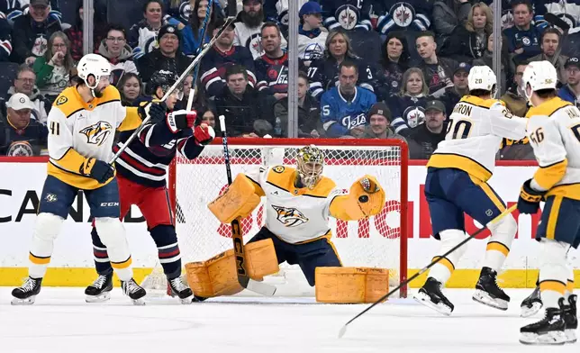 Nashville Predators goaltender Juuse Saros (74) makes a save on a Winnipeg Jets shot during the first period of their NHL hockey game in Winnipeg, Tuesday March 17, 2026. THE CANADIAN PRESS/Fred Greenslade/The Canadian Press via AP)