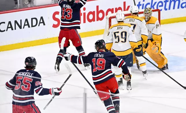 Winnipeg Jets' Jonathan Toews (19) celebrates his goal on the Nashville Predators during the third period of their NHL hockey game in Winnipeg, Tuesday March 17, 2026. (Fred Greenslade/The Canadian Press via AP)