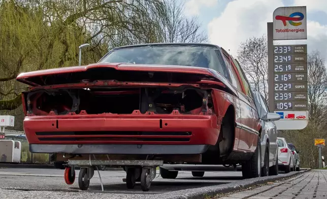 A wrecked gar stands at a gas station in Brombach near Frankfurt, Germany, Tuesday, March 31, 2026. (AP Photo/Michael Probst)
