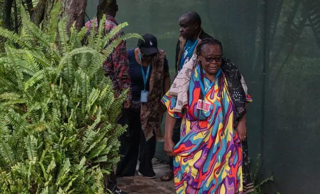 UNICEF staff members mourn at the home of their colleague who was killed in a drone strike in Goma, Democratic Republic of Congo, Wednesday, March 11, 2026. (AP Photo/Moses Sawasawa)