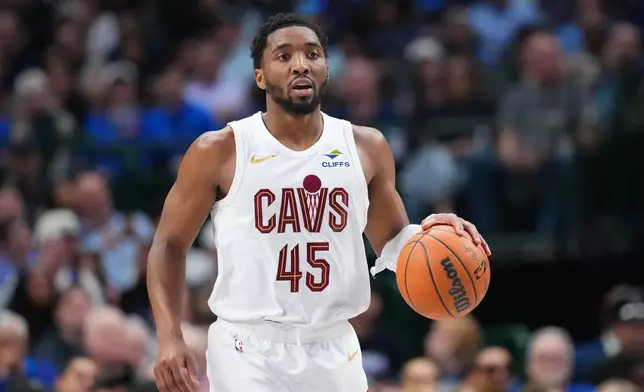 Cleveland Cavaliers guard Donovan Mitchell dribbles up court against the Dallas Mavericks during the second half of an NBA basketball game Friday, March 13, 2026, in Dallas. (AP Photo/Julio Cortez)