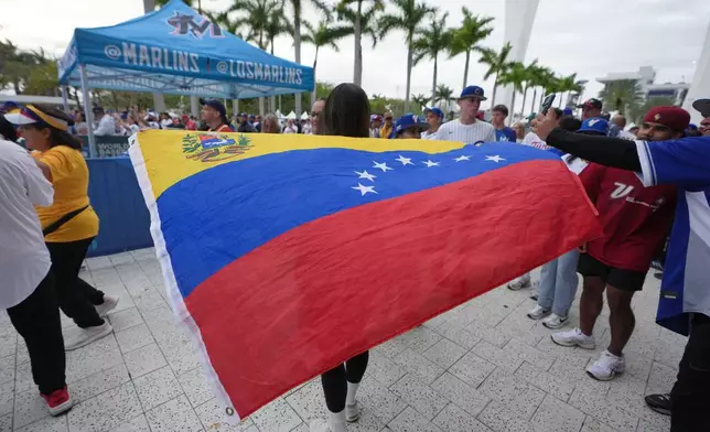 Venezuela fans gather before the championship game of the World Baseball Classic against the United States, Tuesday, March 17, 2026, in Miami. (AP Photo/Lynne Sladky)