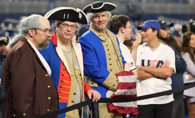 United States fans watch batting practice before the championship game of the World Baseball Classic against Venezuela, Tuesday, March 17, 2026, in Miami. (AP Photo/Lynne Sladky)