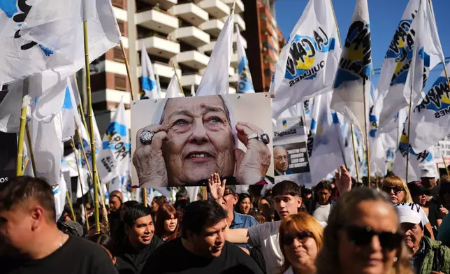 Demonstrators rally with a portrait of Hebe de Bonafini, a late member of the Mothers of Plaza de Mayo human rights group, on the anniversary of the military coup that brought the military regime to power, in Buenos Aires, Argentina, Tuesday, March 24, 2026. (AP Photo/Rodrigo Abd)
