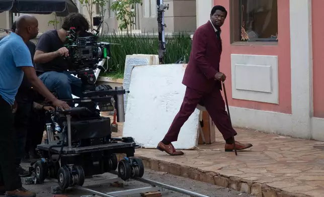 Actor Bukassa Kabengele, right, takes part in the filming of the soap opera "A Nobreza do Amor" at a TV Globo set in Rio de Janeiro, Thursday, March 12, 2026. (AP Photo/Bruna Prado)