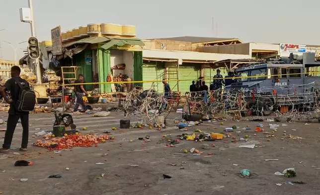 Police officers secure the scene of Monday'sc bomb blast at a market in Maiduguri, Nigeria, Tuesday, March 17, 2026. (AP Photo/Jossy Ola)