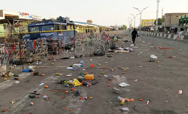 A security person patrols at the scene of Monday's bomb blast at a market in Maiduguri, Nigeria, Tuesday, March 17, 2026. (AP Photo/Jossy Ola )