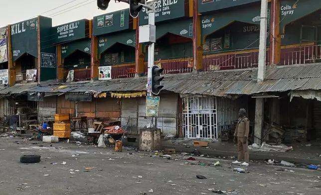 A security person stands guard following Monday's bomb blast at a market in Maiduguri, Nigeria, Tuesday, March 17, 2026. (AP Photo/Jossy Ola)