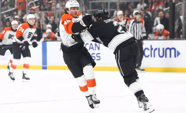 Philadelphia Flyers center Trevor Zegras (46) battles against Los Angeles Kings defenseman Brian Dumoulin (2) during the first period of an NHL hockey game, Thursday, March 19, 2026, in Los Angeles. (AP Photo/Jessie Alcheh)