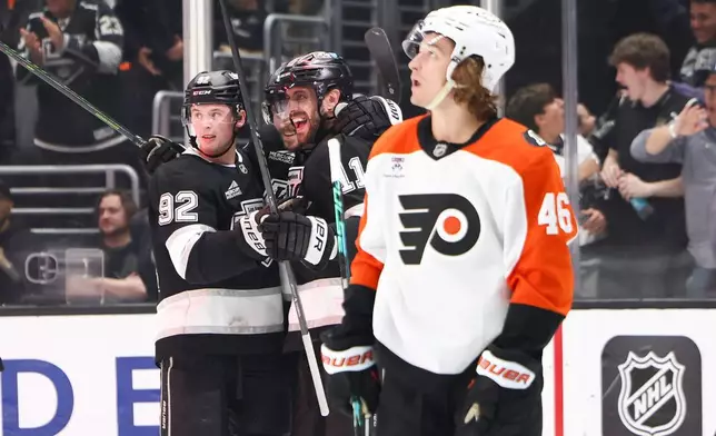 Los Angeles Kings center Anze Kopitar, second from right, celebrates with right wing Adrian Kempe, third from right, and defenseman Brandt Clarke, left, as Philadelphia Flyers center Trevor Zegras (46) looks on during the second period of an NHL hockey game, Thursday, March 19, 2026, in Los Angeles. (AP Photo/Jessie Alcheh)