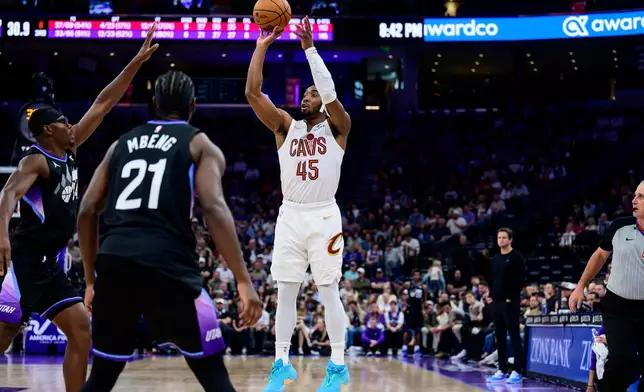 Cleveland Cavaliers guard Donovan Mitchell (45) shoots over Utah Jazz center Oscar Tshiebwe, left, during the second half of an NBA basketball game, Monday, March 30, 2026, in Salt Lake City. (AP Photo/Tyler Tate)