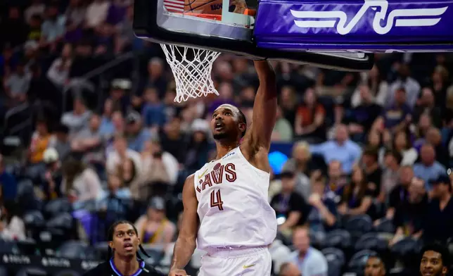 Cleveland Cavaliers center Evan Mobley (4) dunks the ball during the second half of an NBA basketball game against the Utah Jazz, Monday, March 30, 2026, in Salt Lake City. (AP Photo/Tyler Tate)