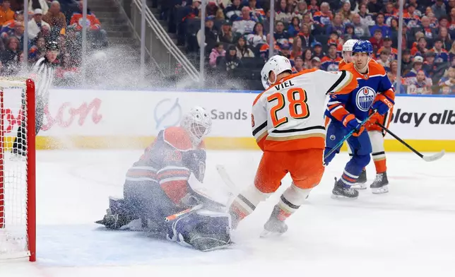 Anaheim Ducks' Jeffrey Viel (28) stops in front of Edmonton Oilers goalie Connor Ingram (39) during the first period of an NHL game, Saturday March 28, 2026, in Edmonton, Alberta. (James Maclennan/The Canadian Press via AP)
