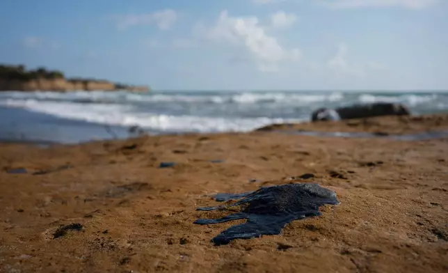 Clumps of oil residue stain the shore after fishing outings were suspended because of an oil spill that Mexican authorities said originated from an unidentified vessel and two natural oil seeps along the Gulf coast in Salinas, Mexico, Thursday, March 26, 2026. (AP Photo/Felix Marquez)