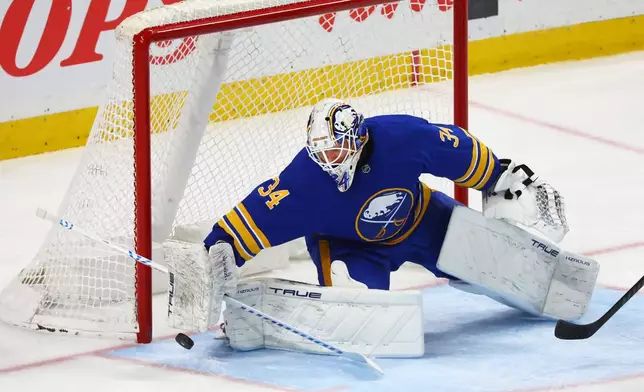 Buffalo Sabres goaltender Alex Lyon (34) makes a blocker save during the third period of an NHL hockey game against the Nashville Predators Saturday, March 7, 2026, in Buffalo, N.Y. (AP Photo/Jeffrey T. Barnes)