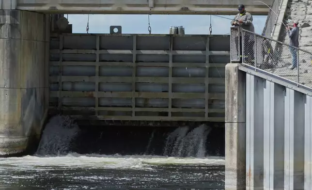 Fisherman throw their lines into the Kirkpatrick Dam spillway Wednesday, March 4, 2026, in Palatka, Fla. (AP Photo/Marta Lavandier)
