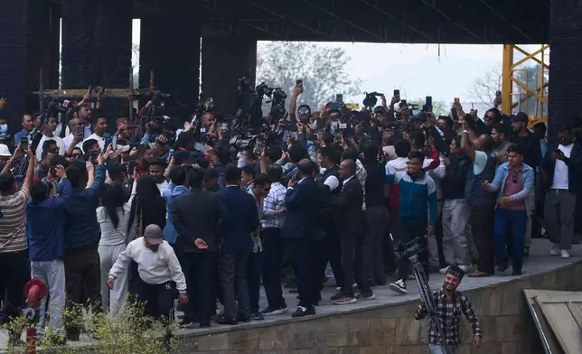 Journalists crowd around Balendra Shah as he arrives for a swearing-in ceremony of newly elected members of the House of Representatives at the Federal Parliament in Kathmandu, Nepal, Thursday, March 26, 2026. (AP Photo/Niranjan Shrestha)