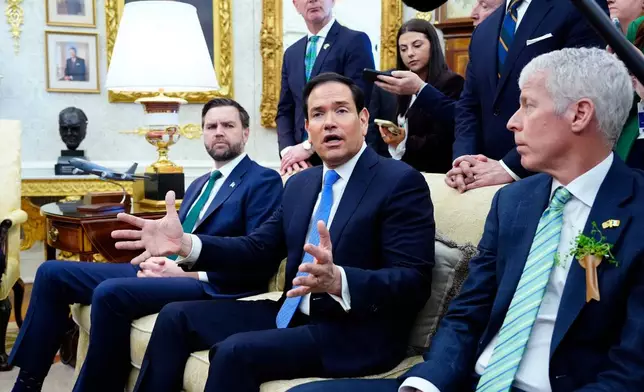 Secretary of State Marco Rubio answers a question about Cuba during a meeting between President Donald Trump and Irish Prime Minister Micheál Martin in the Oval Office of the White House, on St. Patrick's Day, Tuesday, March 17, 2026, in Washington. (AP Photo/Alex Brandon)