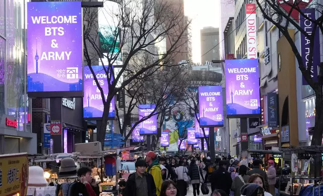 Messages welcoming BTS fans are displayed on screens ahead of a comeback concert of K-pop group BTS at a shopping street in Seoul, South Korea, Thursday, March 19, 2026. (AP Photo/Ahn Young-joon)