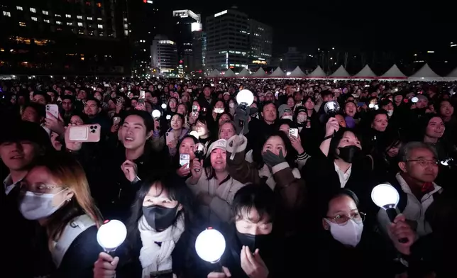Fans react during a comeback concert of K-pop band BTS near Gwanghwamun Square in Seoul, South Korea, Saturday, March 21, 2026. (AP Photo/Ahn Young-joon)