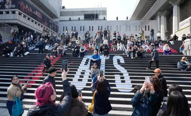 People gather ahead of a comeback concert of K-pop band BTS at Gwanghwamun Square in Seoul, South Korea, Friday, March 20, 2026. (AP Photo/Ahn Young-joon)