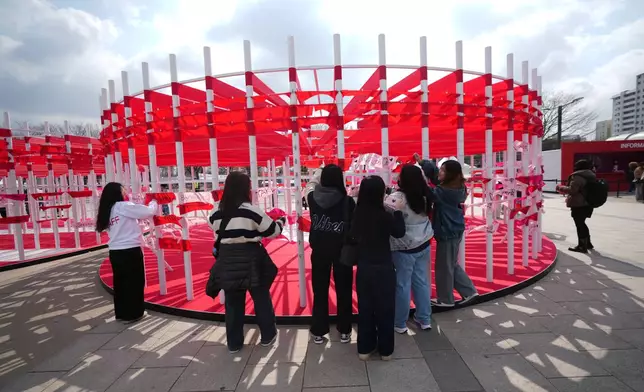 Fans of K-pop band BTS hang banners for BTS on the wall at a fan zone promoting the news album of BTS near the Han River in Seoul, South Korea, Friday, March 20, 2026. (AP Photo/Lee Jin-man)