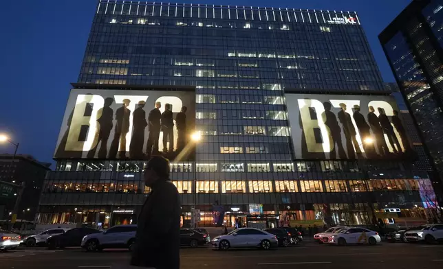 K-pop band BTS is displayed on big screens on a building in downtown Seoul, South Korea, Monday, March 16, 2026. (AP Photo/Lee Jin-man)