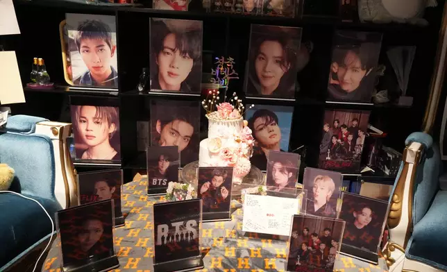 Photos of K-pop band BTS members are displayed at a cafe in Seoul, South Korea, Tuesday, March 17, 2026. (AP Photo/Lee Jin-man)
