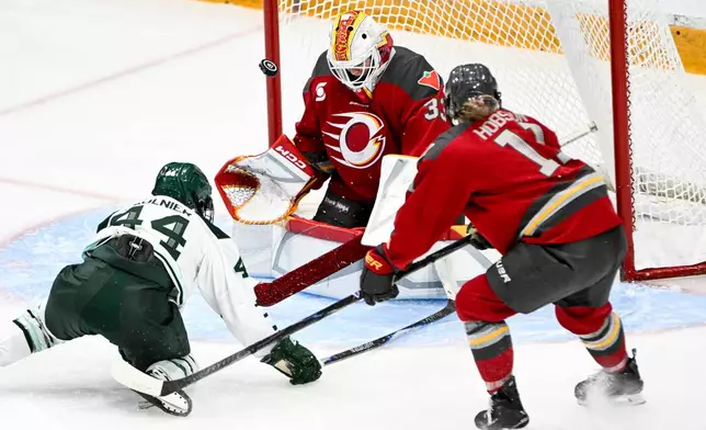 Ottawa Charge's goaltender Gwyneth Philips (33) blocks a shot from Boston Fleet's Jill Saulnier (44) during the third period of an PWHL hockey game in Ottawa, Saturday, Feb. 28, 2026. (Spencer Colby/The Canadian Press via AP)