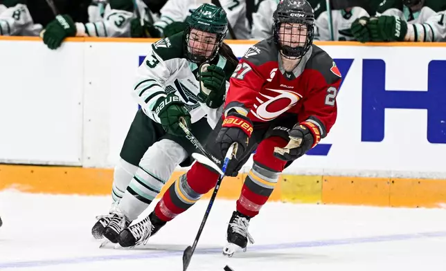 Boston Fleet's Liz Schepers (13) chases down Ottawa Charge's Brooke McQuigge (27) for control of the puck during the second period of an PWHL hockey game in Ottawa, Saturday, Feb. 28, 2026. (Spencer Colby/The Canadian Press via AP)