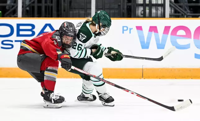 Ottawa Charge's Jocelyne Larocque (3) chases down Boston Fleet's Ella Huber (26) during the second period of an PWHL hockey game in Ottawa, Saturday, Feb. 28, 2026. (Spencer Colby/The Canadian Press via AP)