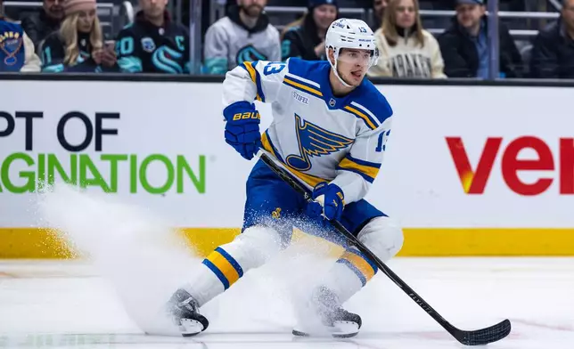 St. Louis Blues right wing Alexey Toropchenko skates with the puck during an NHL hockey game against the Seattle Kraken, Wednesday, March 4, 2026, in Seattle. (AP Photo/Maddy Grassy)