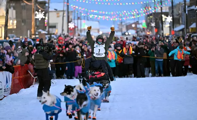 Jessie Holmes arrives first to the finish lane, claiming his second straight Iditarod Trail Sled Dog Race championship, in Nome, Alaska, Tuesday March 17, 2026. (Marc Lester/Anchorage Daily News via AP)