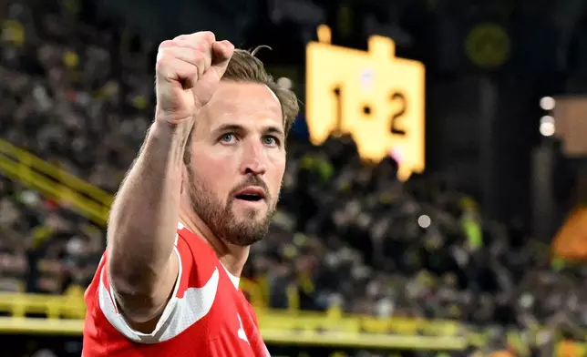 Bayern Munich's Harry Kane celebrates scoring during the Bundesliga soccer match between Borussia Dortmund and FC Bayern Munich in Dortmund, Germany, Saturday Feb. 28, 2026. (Federico Gambarini/dpa via AP)