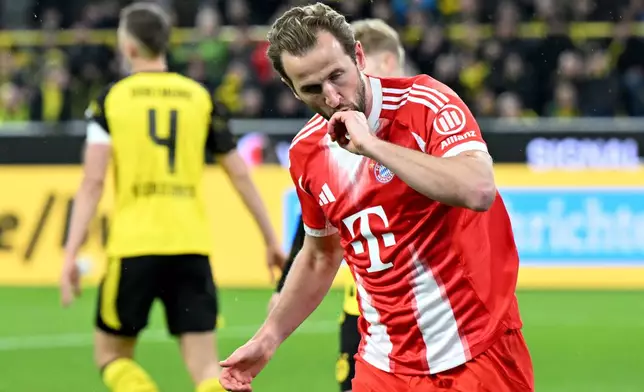 Bayern Munich's Harry Kane celebrates scoring during the Bundesliga soccer match between Borussia Dortmund and FC Bayern Munich in Dortmund, Germany, Saturday Feb. 28, 2026. (Federico Gambarini/dpa via AP)