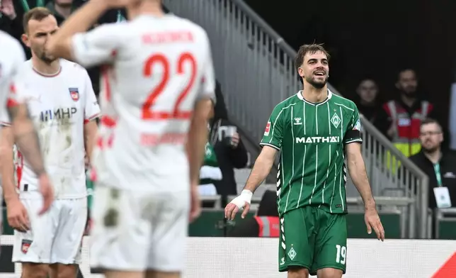 Werder's Jovan Milosevic, right, celebrates after scoring the opening goal during the German Bundesliga soccer match between Werder Bremen and 1. FC Heidenheim, in Bremen, Germany, Saturday, Feb. 28, 2026. (Carmen Jaspersen/dpa via AP)